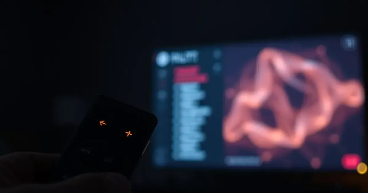 A glowing Firestick remote in a dark room with a TV screen showing two contrasting streams of light representing different IPTV connection formats
